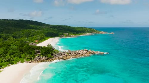 Tropical Beach with Lush Greenery and Turquoise Waters La Digue Seychelles