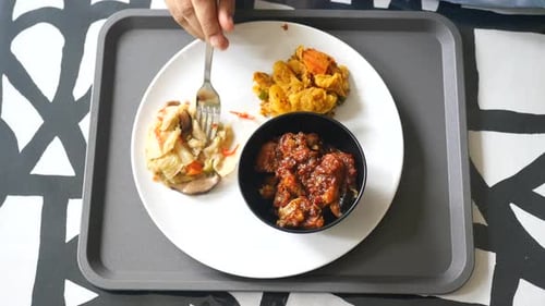 Cooked Red Rice Vegetable Salad and Fish Curry in a Bowl on Table