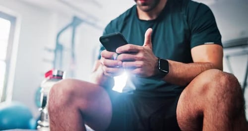 Break, exercise and man with phone in gym relax after fitness, training and workout routine