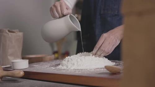 Person mixes flour and water with hands