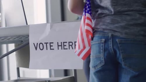 Vote Here Sign on Table in American Polling Place Alone