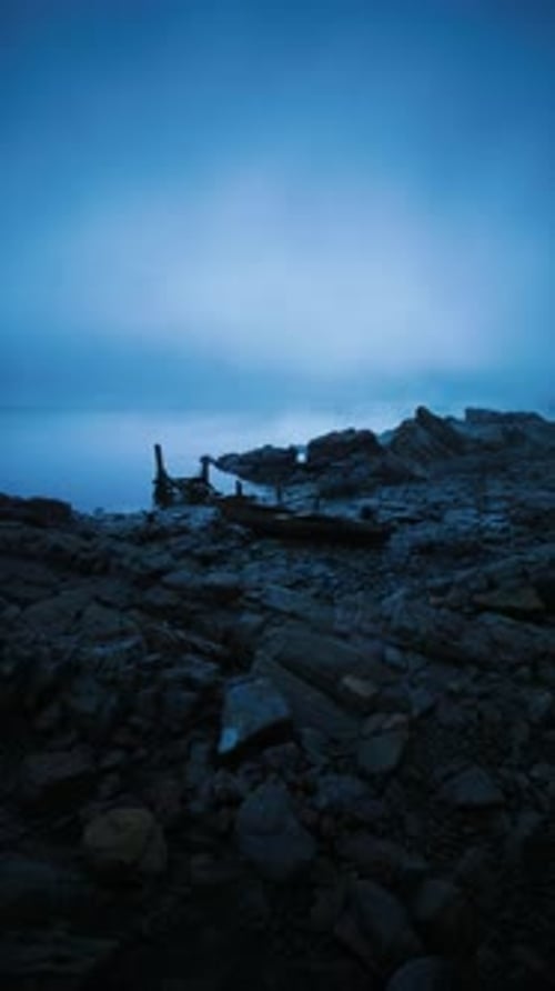 Mysterious Shoreline at Twilight Reveals Rugged Rocks and Gentle Waters
