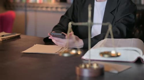 Close Up of Judge using Smartphone in Court