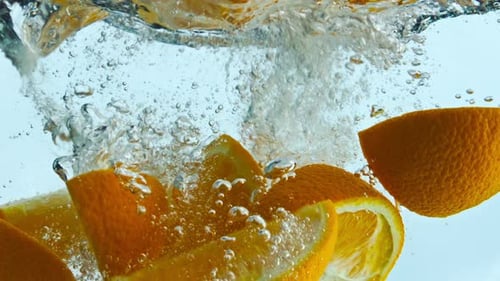 Orange Wedges Splashing Water in Super Slow Motion Close Up