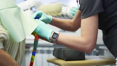 Nurse Puts on a Blood Tourniquet on Patient's Arm Preparation for Blood Test with By Female Doctor