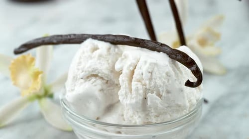 Vanilla ice cream with vanilla bean garnish closeup