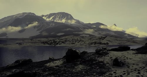 Majestic Mountain Landscape with Serene Lake and Clouds at Twilight
