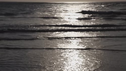 Beach waves at sunse