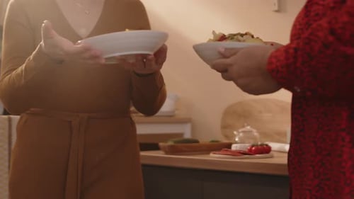 Women Setting Table for Dinner Party at Home
