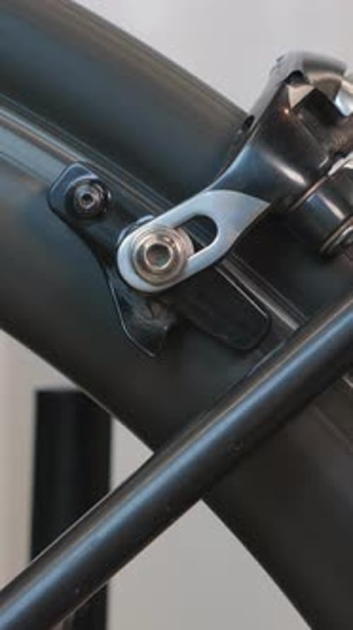Bicycle wheel in motion. Close up of rear wheel of road bicycle. Vertical video