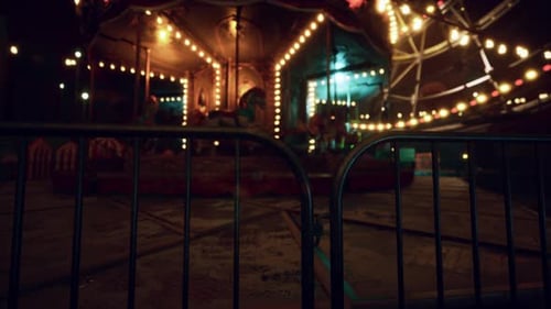 Nighttime Abandoned Carousel with Glowing Lights in Empty Park