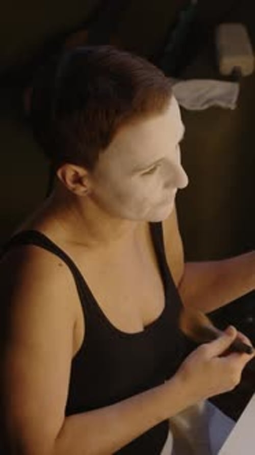 Vertical of Mime Actress Doing Makeup in front of Backstage Mirror