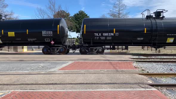 black train passing on railroad and blocking street, Vehicles Stock ...