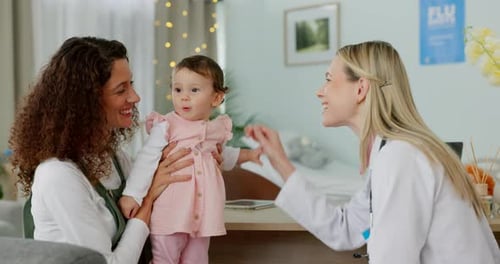 Mother and Baby Talking to Female Doctor