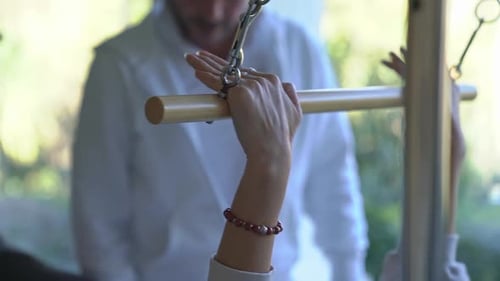 Woman Doing Pilates Exercises on a Pilates Machine