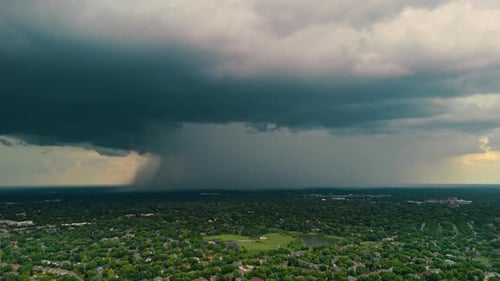 Epic Skyline with Dark Stormy Clouds with Falling Rain Above Green Suburbs Stormy Heaven with