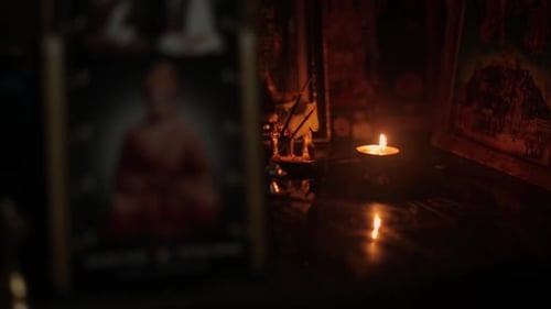 Traditional Indian oil lamp lit on altar. Static, shallow focus