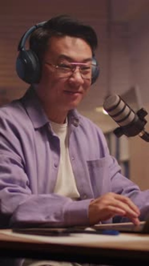 Modern Audio Producer Captured During Live Stream with Dynamic Hand Movements and Colorful