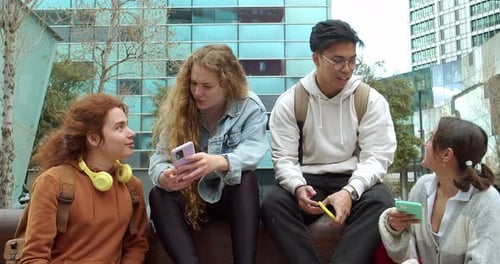 Young Adults Enjoying Smartphones in Urban Setting