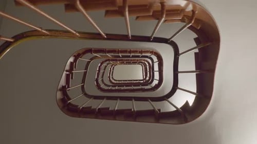 Spiral staircase looking downward, showcasing intricate design and architectural beauty