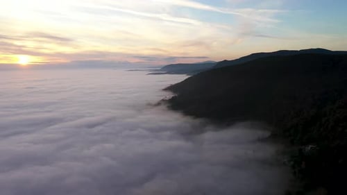Sea of clouds in the sunset by the mountains -aerial