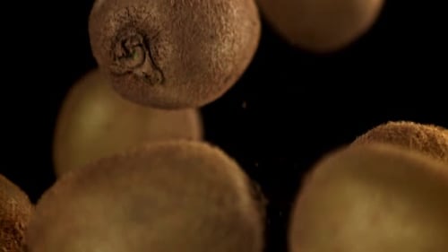 Falling Kiwis in Dark Studio for Food Concept