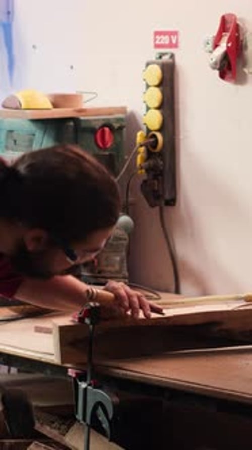 Vertical Video Woodworker Using Bench Vise to Hold Lumber Block Carving Intricate Designs