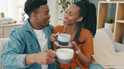Young Couple Enjoying Drinks and Relaxing at Home