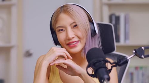 Young Adult Woman with Headphones Smiles at Camera