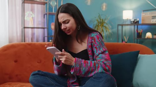 Upset Woman Cries While Using Mobile Phone