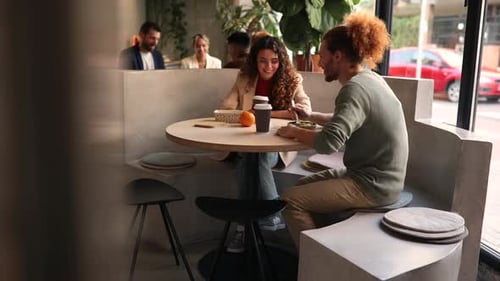 Animated Discussion Among Diverse Team in Modern Lounge