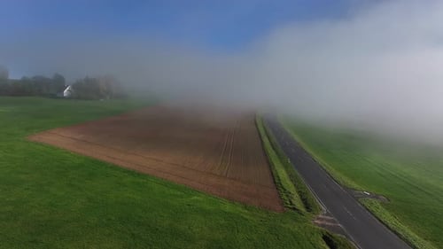 Aerial view of road and fields in fog, Germany.