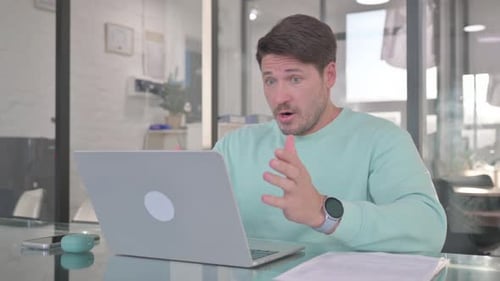 Casual Man Shocked by Loss on Laptop
