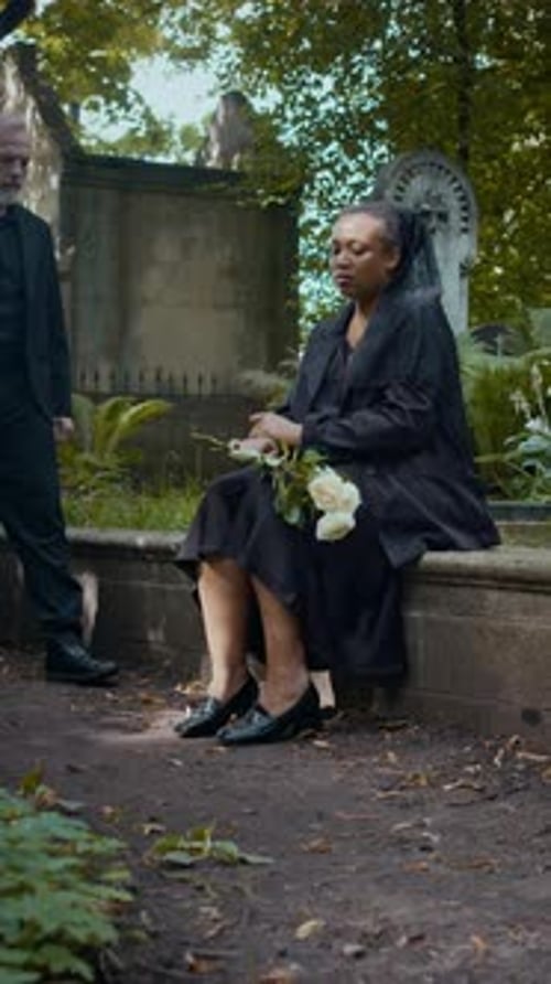 Couple Grappling with Grief in Cemetery