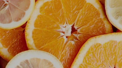Close-Up of Fresh Orange Slices in Bright Citrus Arrangement | 4K Video