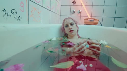 Young Woman Relaxing in a Flower-Filled Bathtub