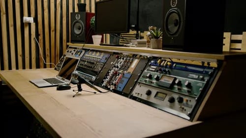 A recording studio control panel mixer with an equalizer faders buttons for broadcasting a recording