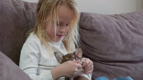 Girl with Small Dog on Couch