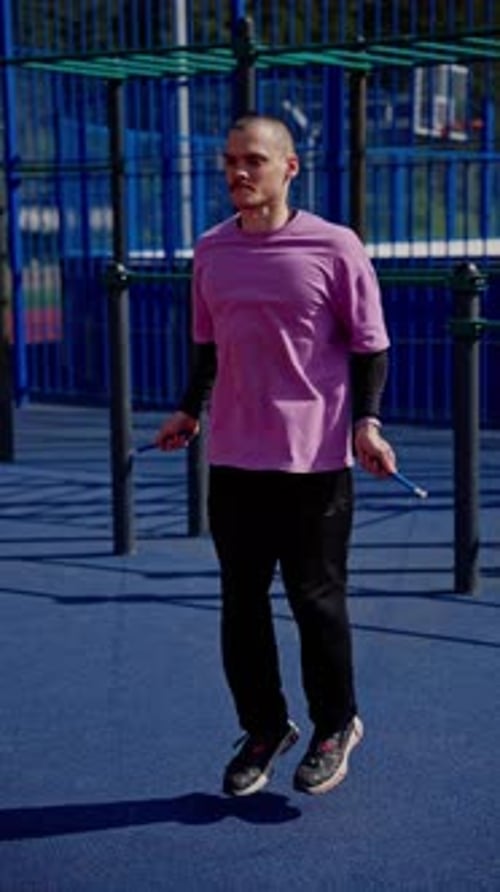 Athletic Man in Slow Motion Jumping Rope in Park