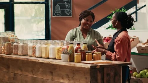 Vendor Presenting Additives Free Bulk Items for Client in Store