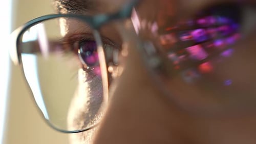 Close-up of Man's Eyes Reflecting Computer Screen