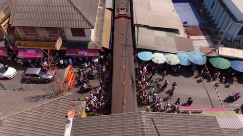 Aerial view of Maeklong Railway Market with trains at Talad Rom Hub, Thailand