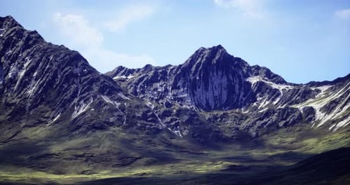 Majestic Mountain Range Surrounded By Lush Green Valleys in Daytime