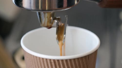 Espresso Machine Dispensing Coffee Into Paper Cup