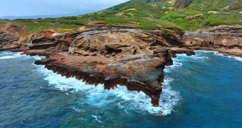 Beautiful ragged bare rocks are hit by the waves of the Pacific Ocean.