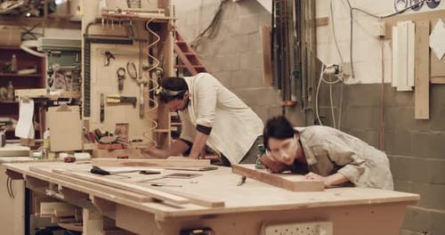 4k video footage of two young carpenters working in their woodworking workshop