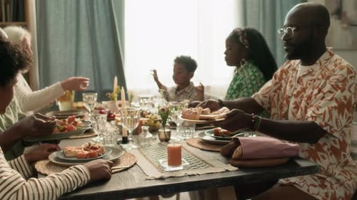 Diverse Family Meal Together Around Wooden Table