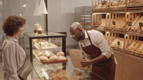 Woman Buying Fresh Croissants at Bakery
