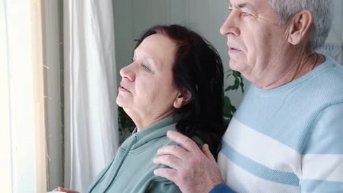 Loving Couple Standing Together by Bright Window