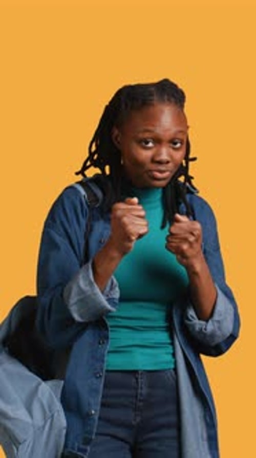 Vertical Video Woman Jokingly Pretending to Fight with Friend Studio Background